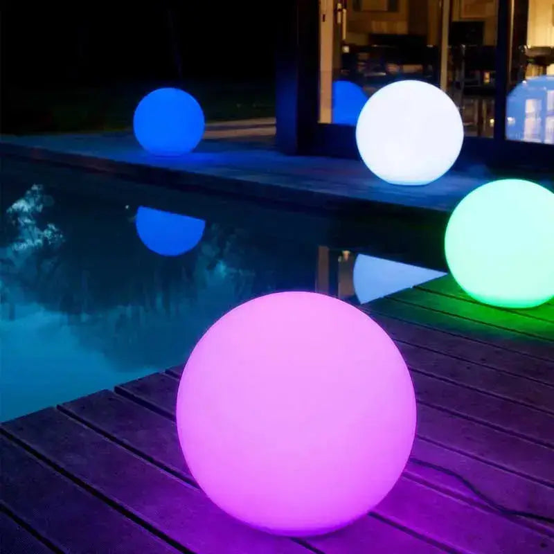 Colorful glowing orbs by the pool at night, adding a modern and vibrant touch to outdoor lighting.