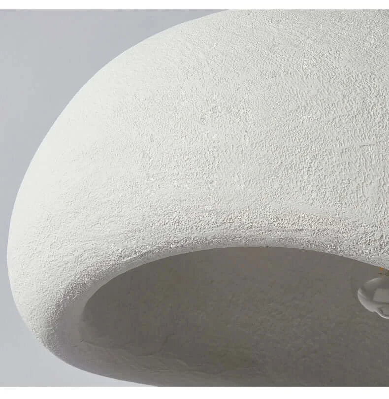 Close-up of the textured white shade of a Nordic minimalist pendant light fixture.