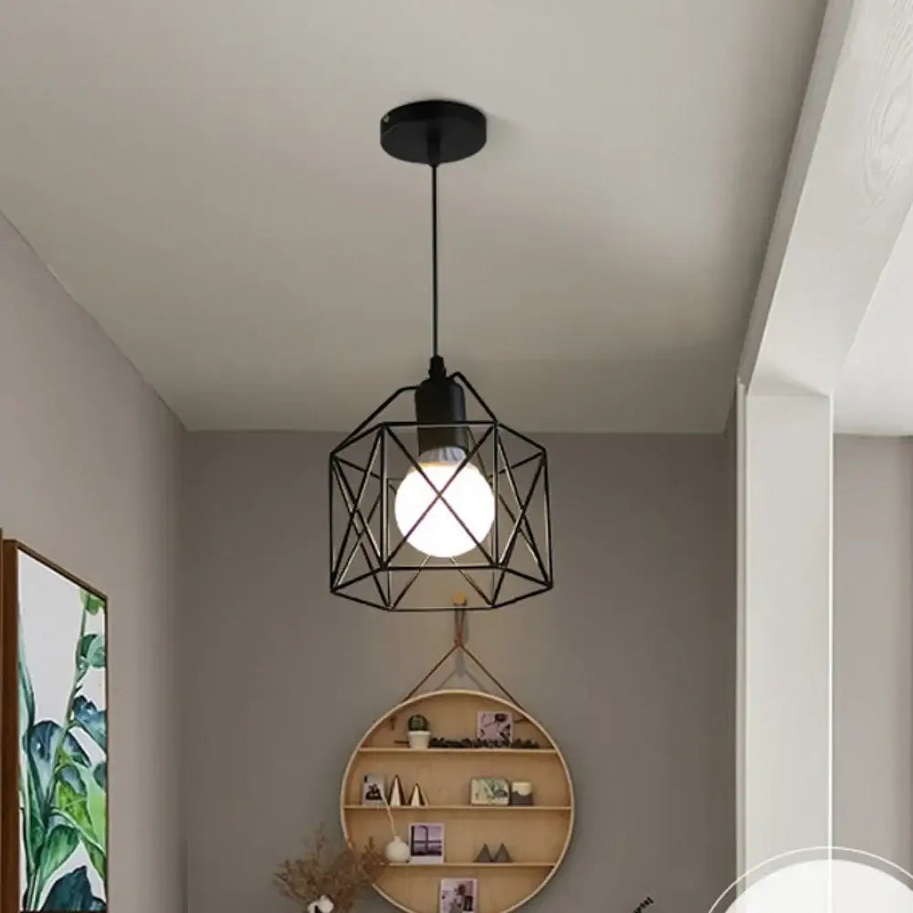 Modern black metal pendant chandelier with geometric design, illuminating a stylish living space.