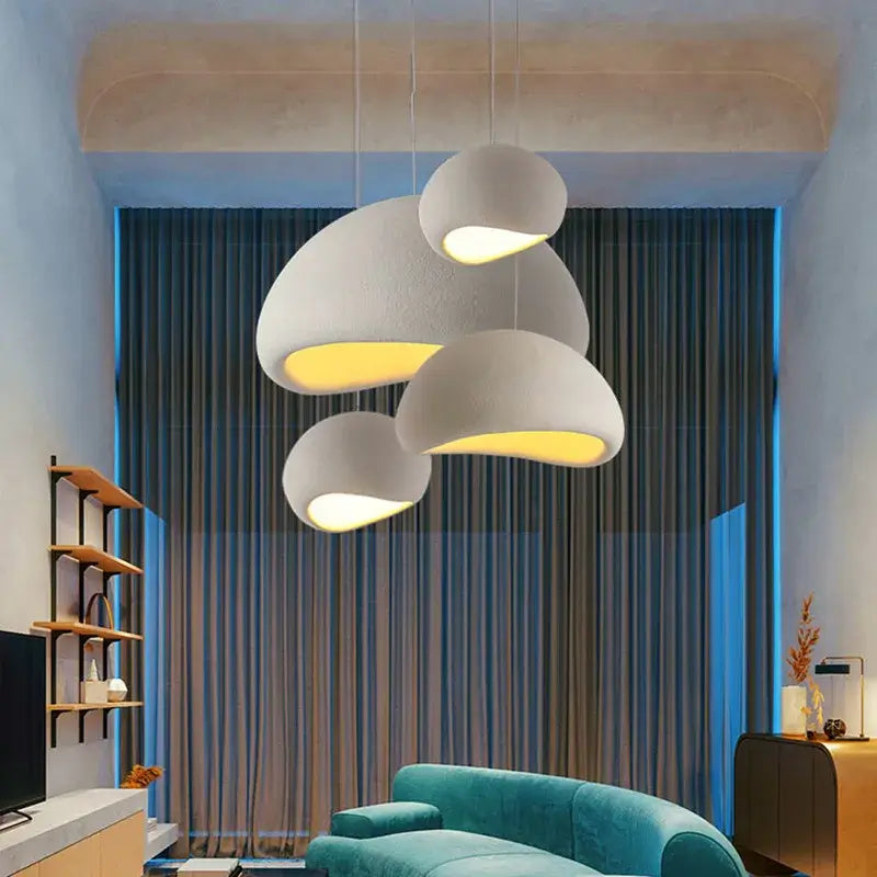 Nordic minimalist pendant lights in a stylish living room with modern decor, enhancing ambiance with soft illumination.