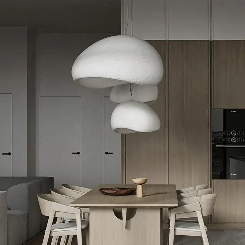 Nordic minimalist pendant lights in a modern dining room with wooden furniture and a stylish decor ambiance.