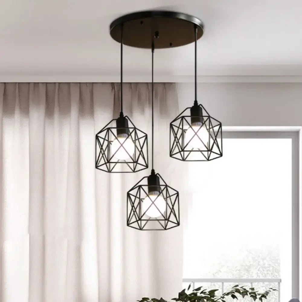 Modern black pendant chandelier with three geometric light fixtures illuminating a room.