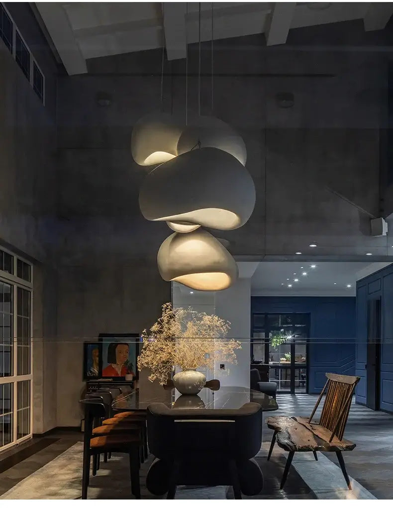 Nordic minimalist Wabi Sabi pendant light illuminating a modern dining area with stylish decor and floral centerpiece.